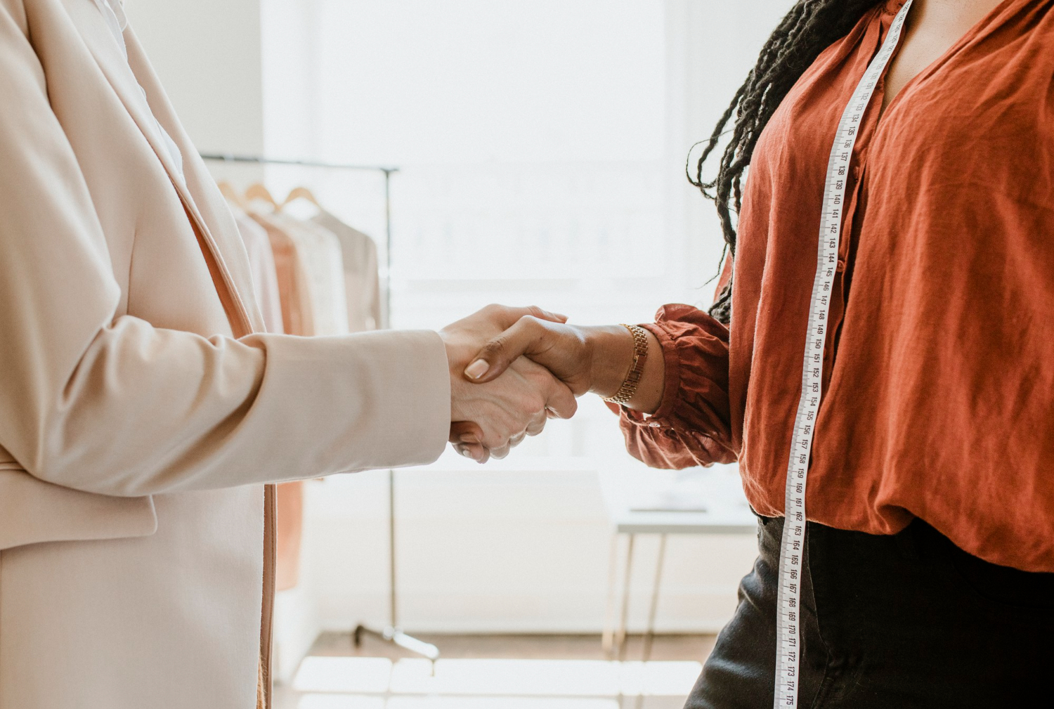 fashion consultant handshaking with brand owner